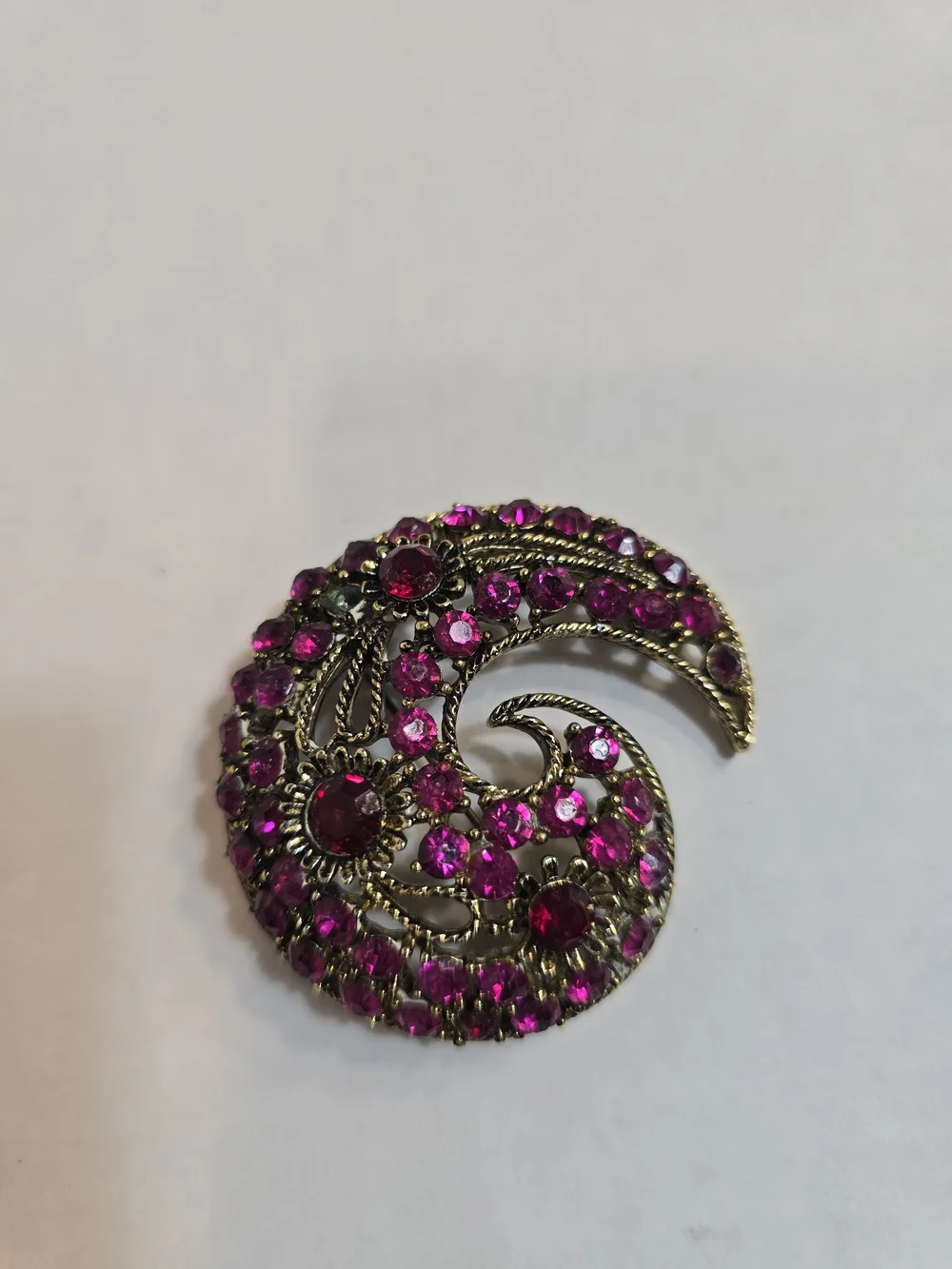 Gold-Tone Swirl Brooch with Vibrant Fuchsia Stones